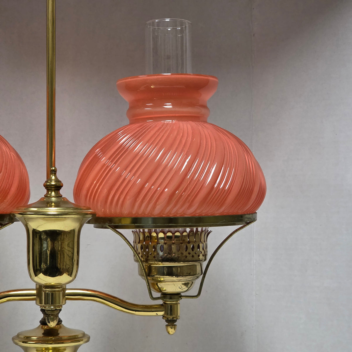 Stunning Victorian brass lamp with pastel pink swirled glass shades.