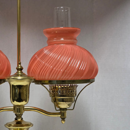 Stunning Victorian brass lamp with pastel pink swirled glass shades.