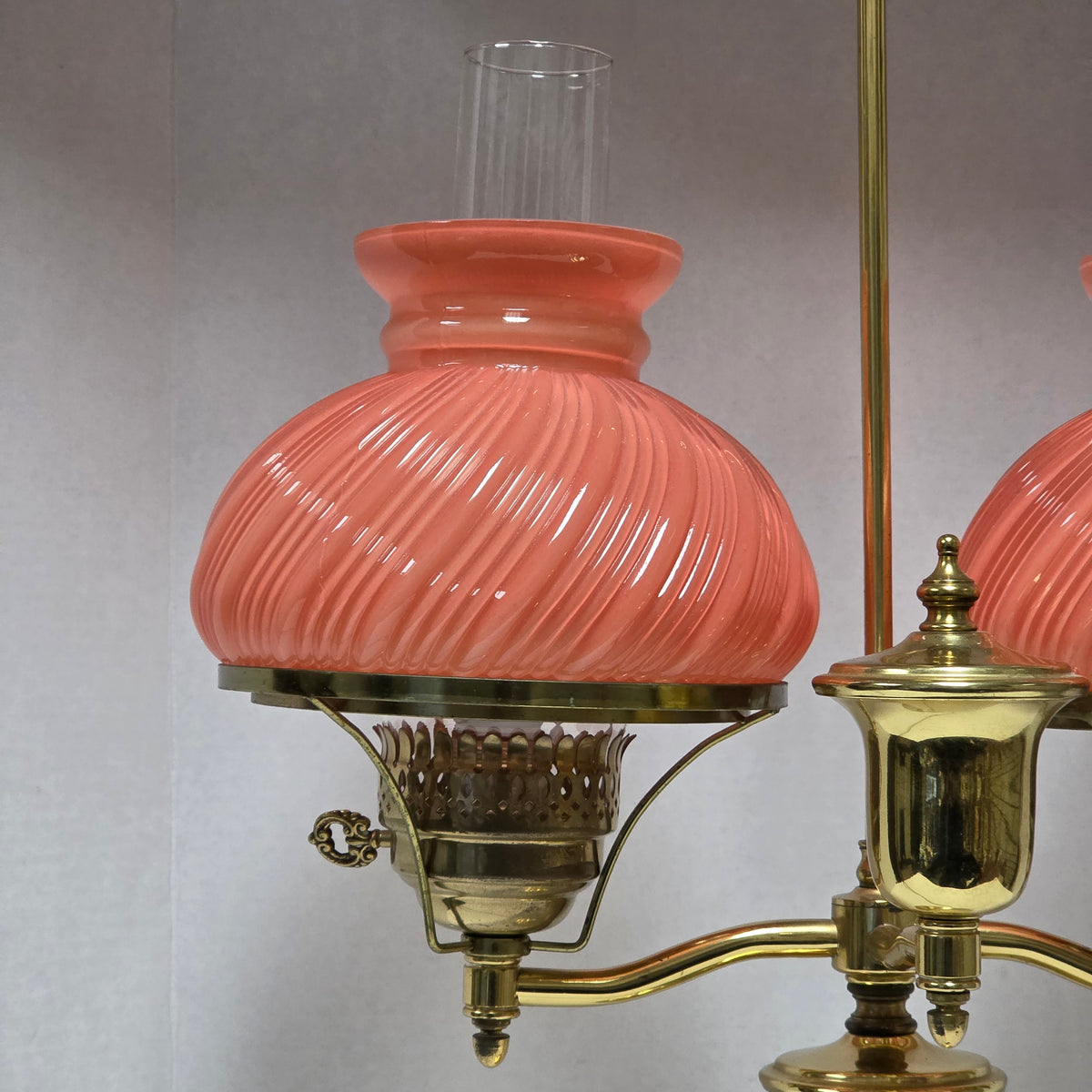Stunning Victorian brass lamp with pastel pink swirled glass shades.