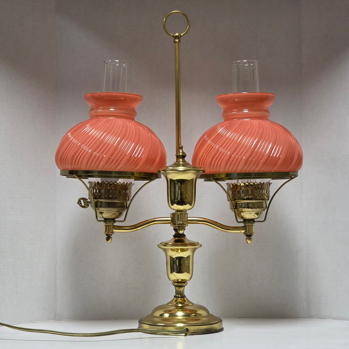 Stunning Victorian brass lamp with pastel pink swirled glass shades.