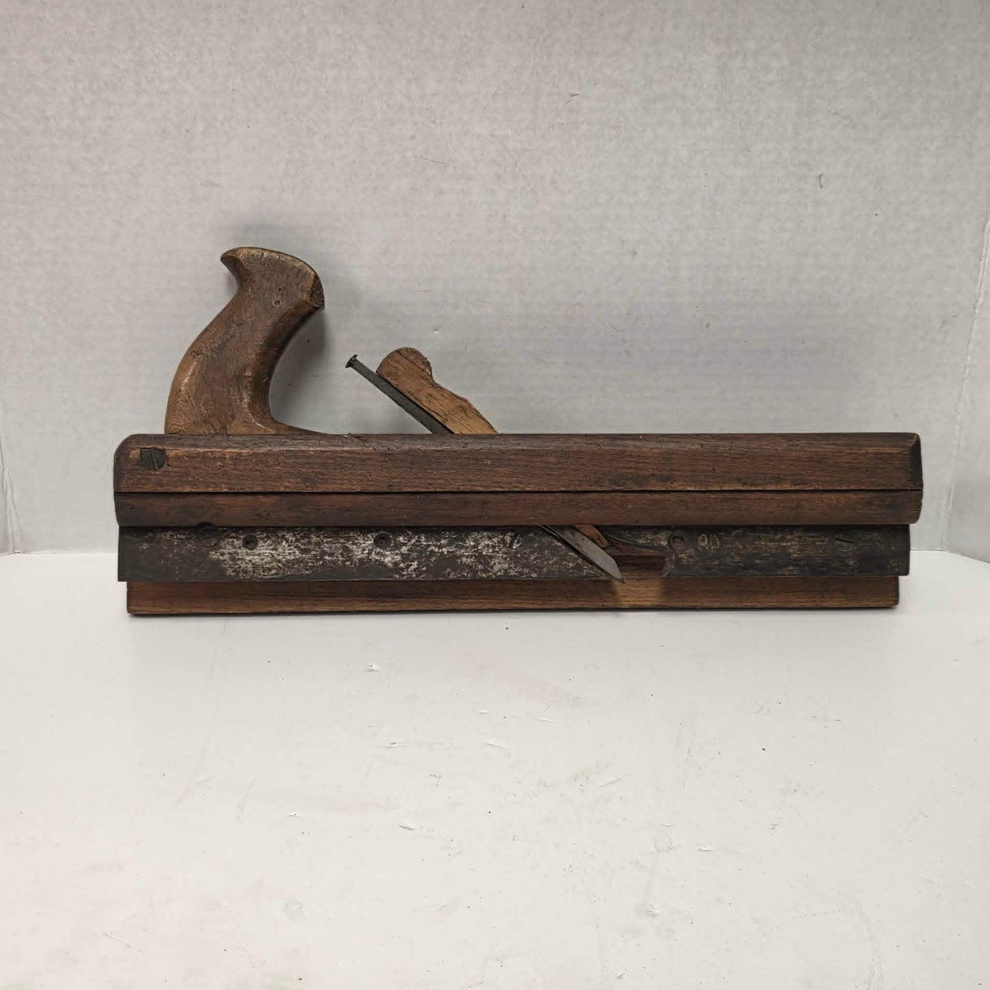 Antique wooden grooving plane with steel rail for tongue and groove woodworking.
