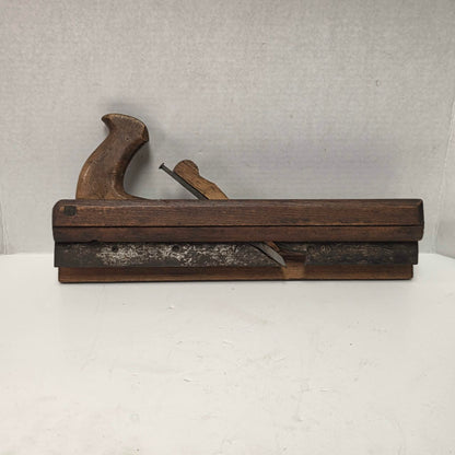 Antique wooden grooving plane with steel rail for tongue and groove woodworking.
