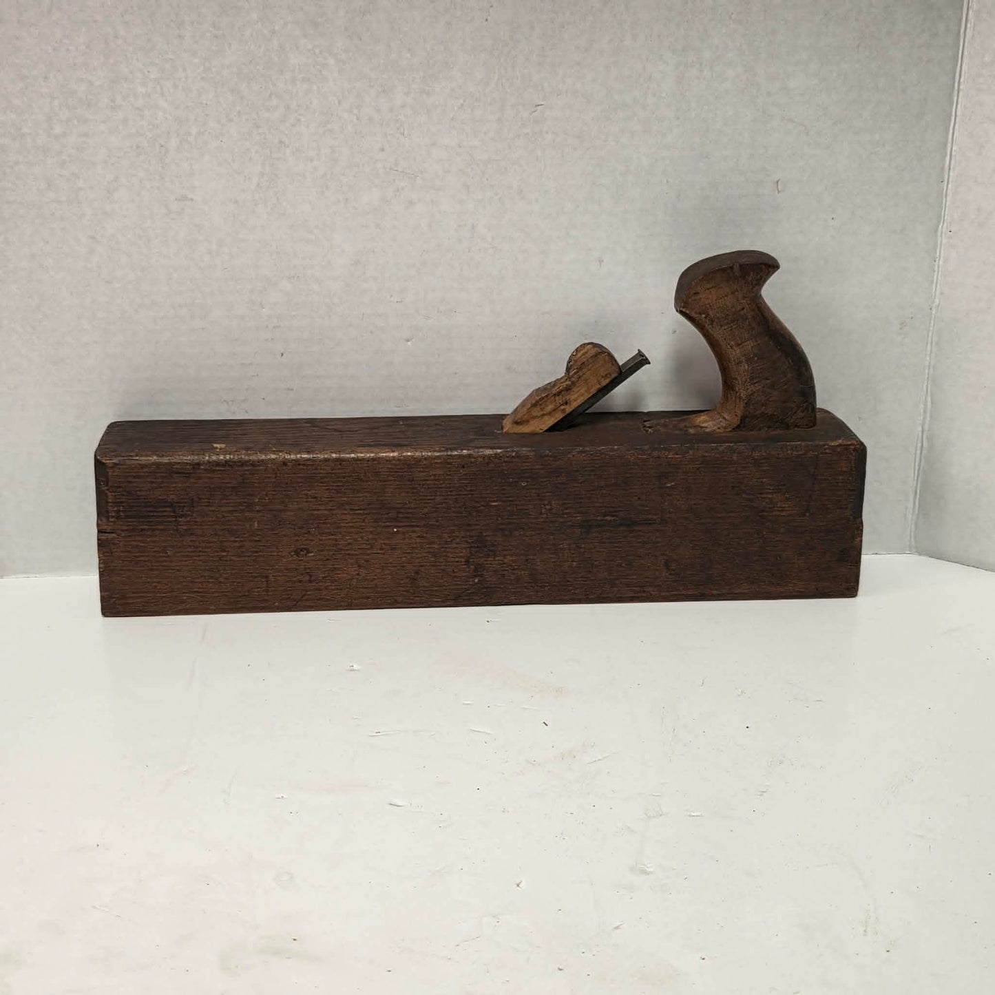Antique wooden grooving plane with steel rail for tongue and groove woodworking.
