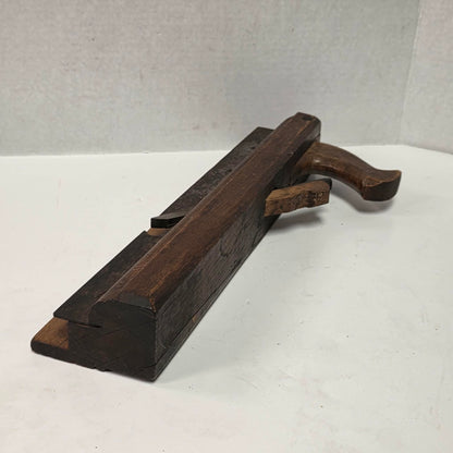 Antique wooden grooving plane with steel rail for tongue and groove woodworking.
