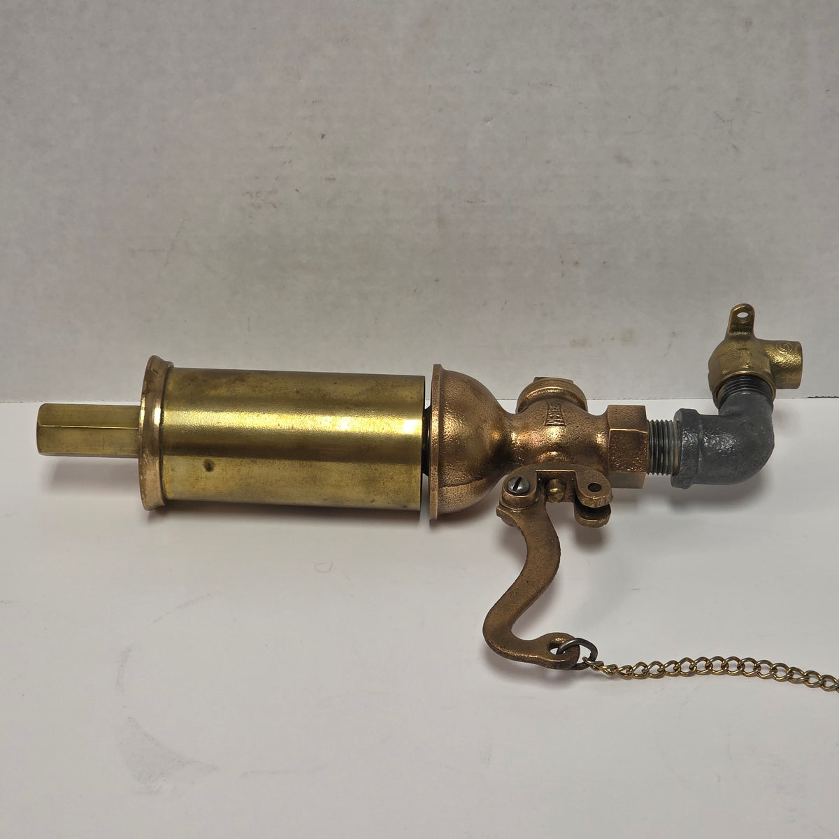 Antique Pemberthy brass steam whistle with iron pipe fitting
