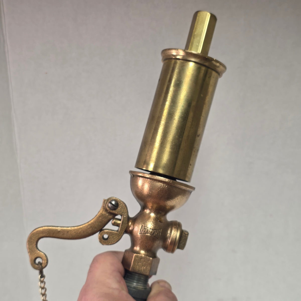 Antique Pemberthy brass steam whistle with iron pipe fitting
