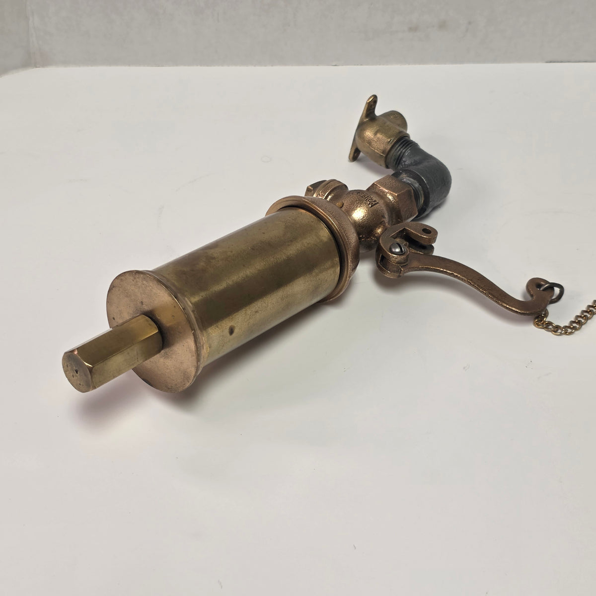 Antique Pemberthy brass steam whistle with iron pipe fitting
