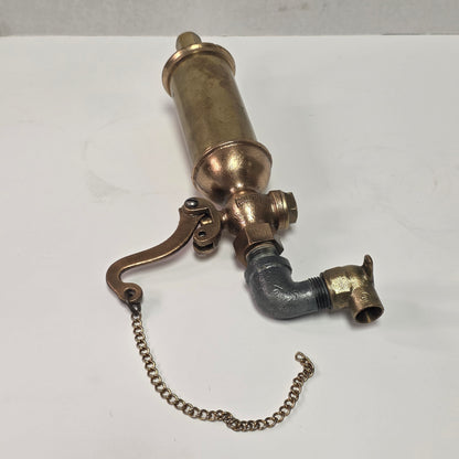 Antique Pemberthy brass steam whistle with iron pipe fitting
