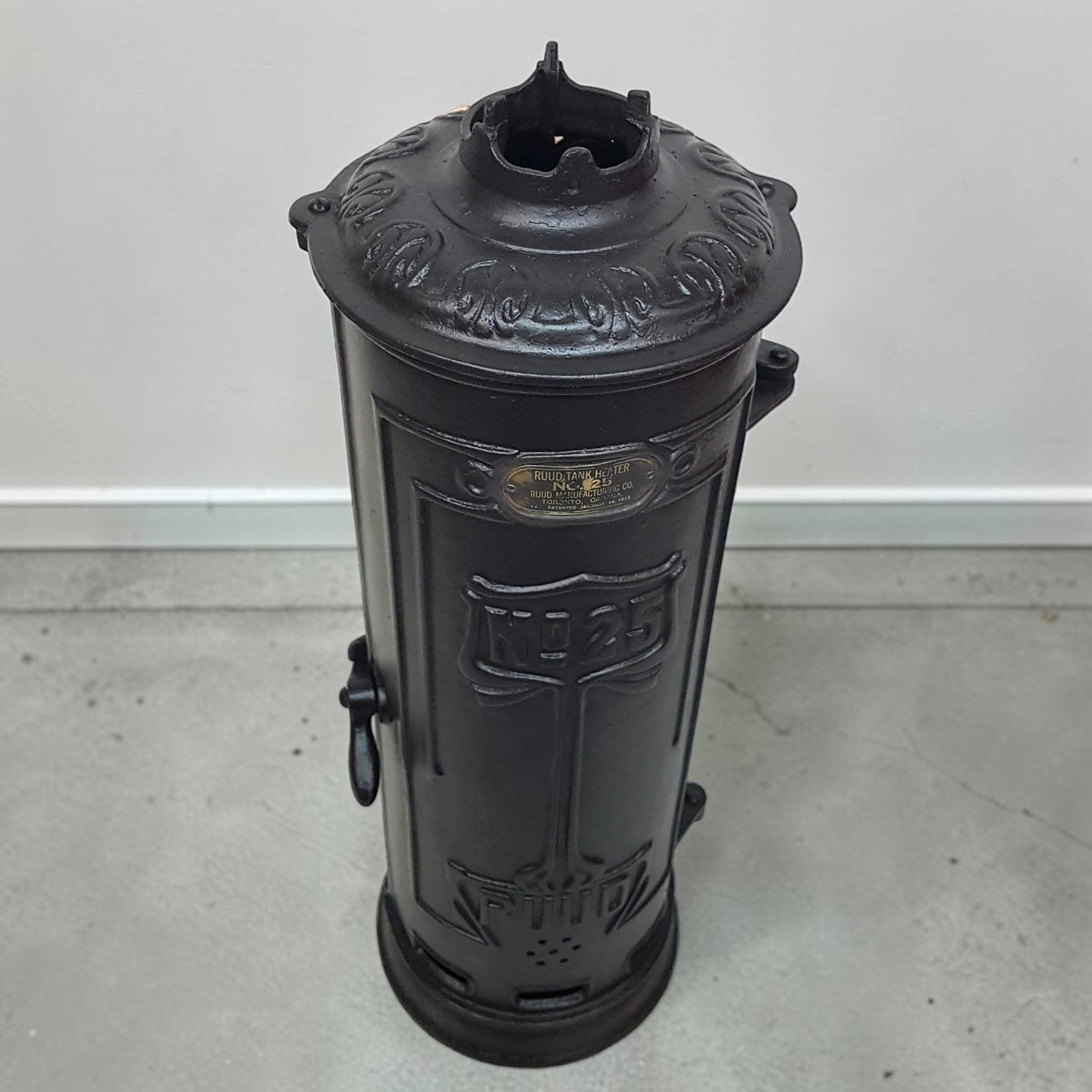 Antique RUUD No. 25 cast iron hot water heater tank.
