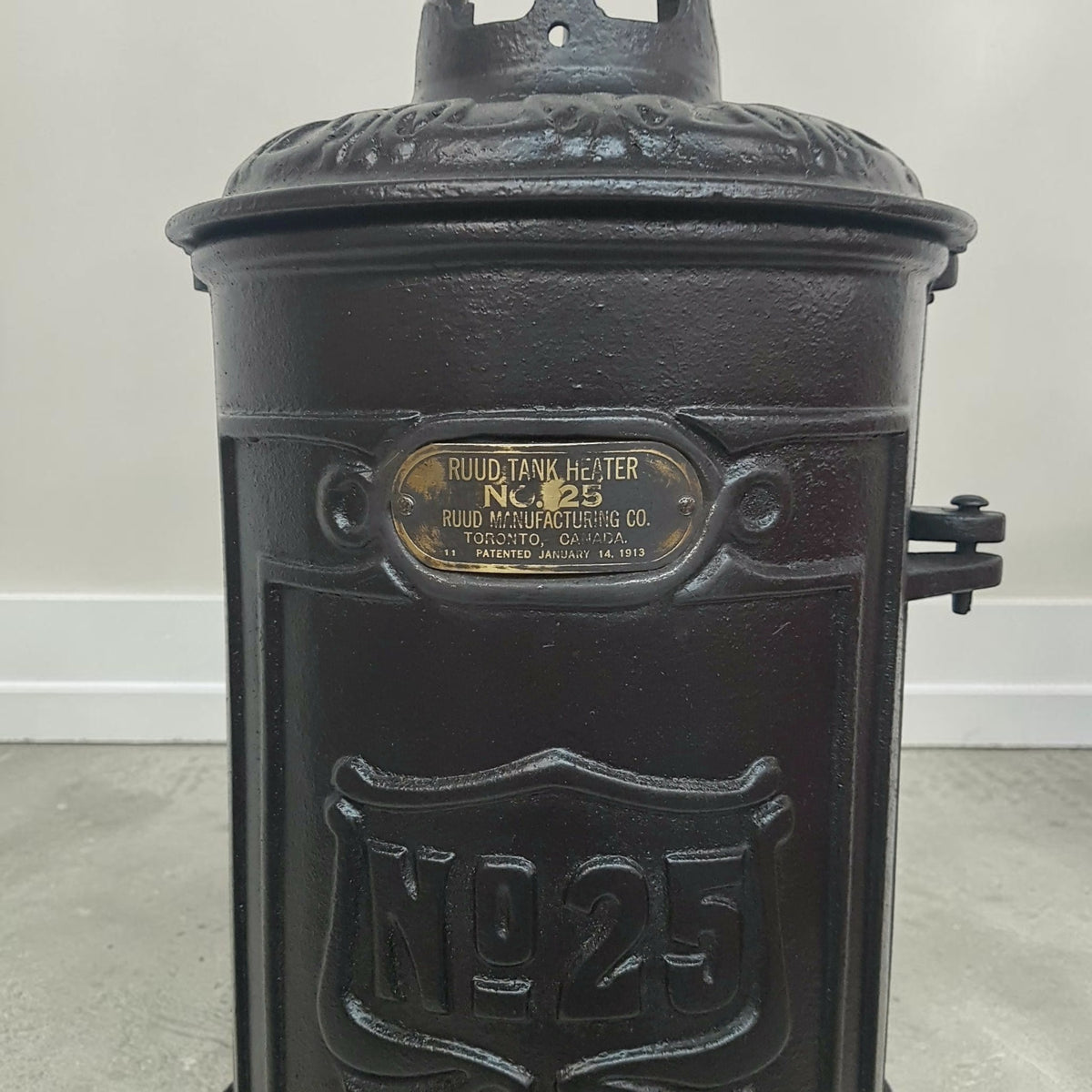 Antique RUUD No. 25 cast iron hot water heater tank.
