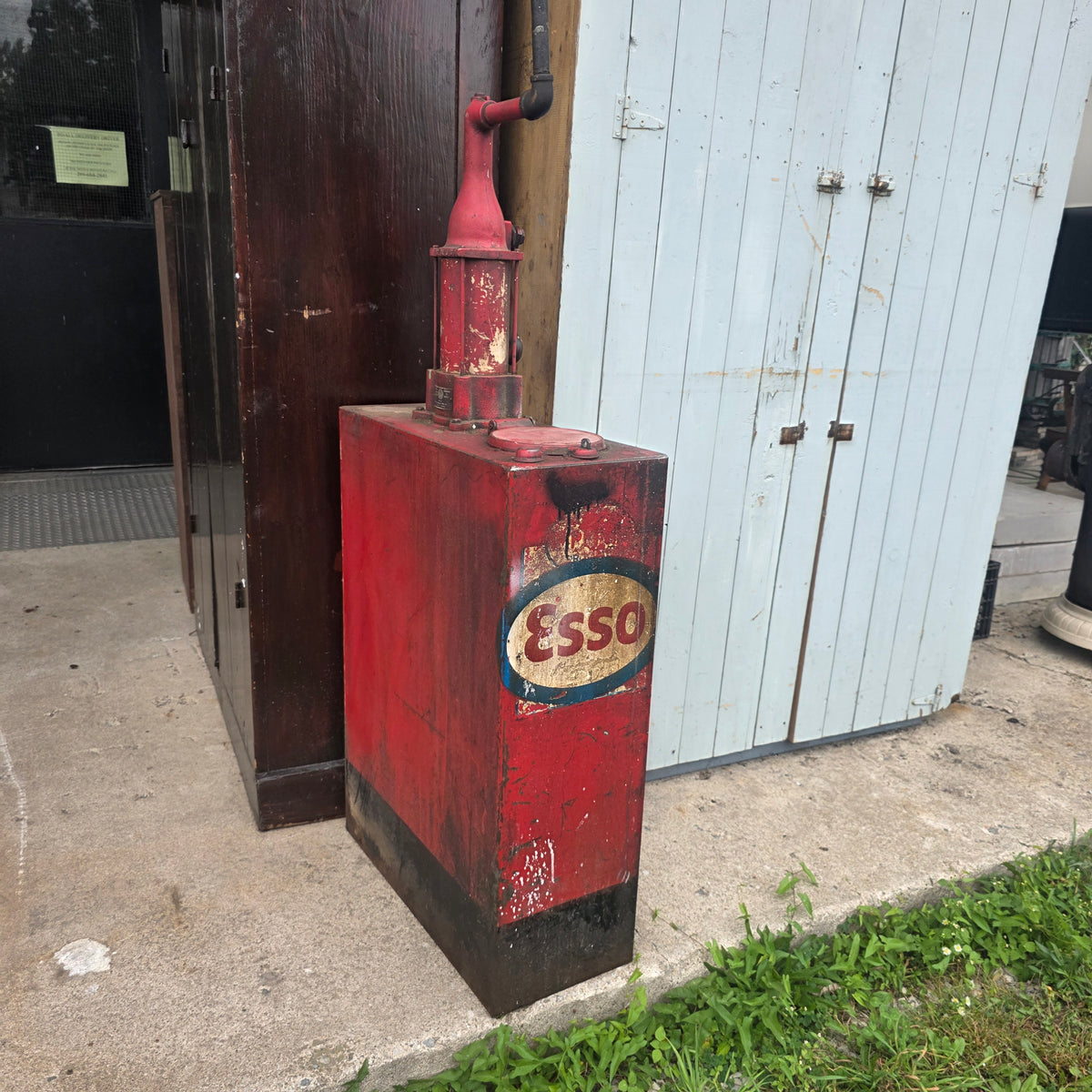 Antique Esso-branded lubester oil tank with Gilbert and Barker brass identification tag
