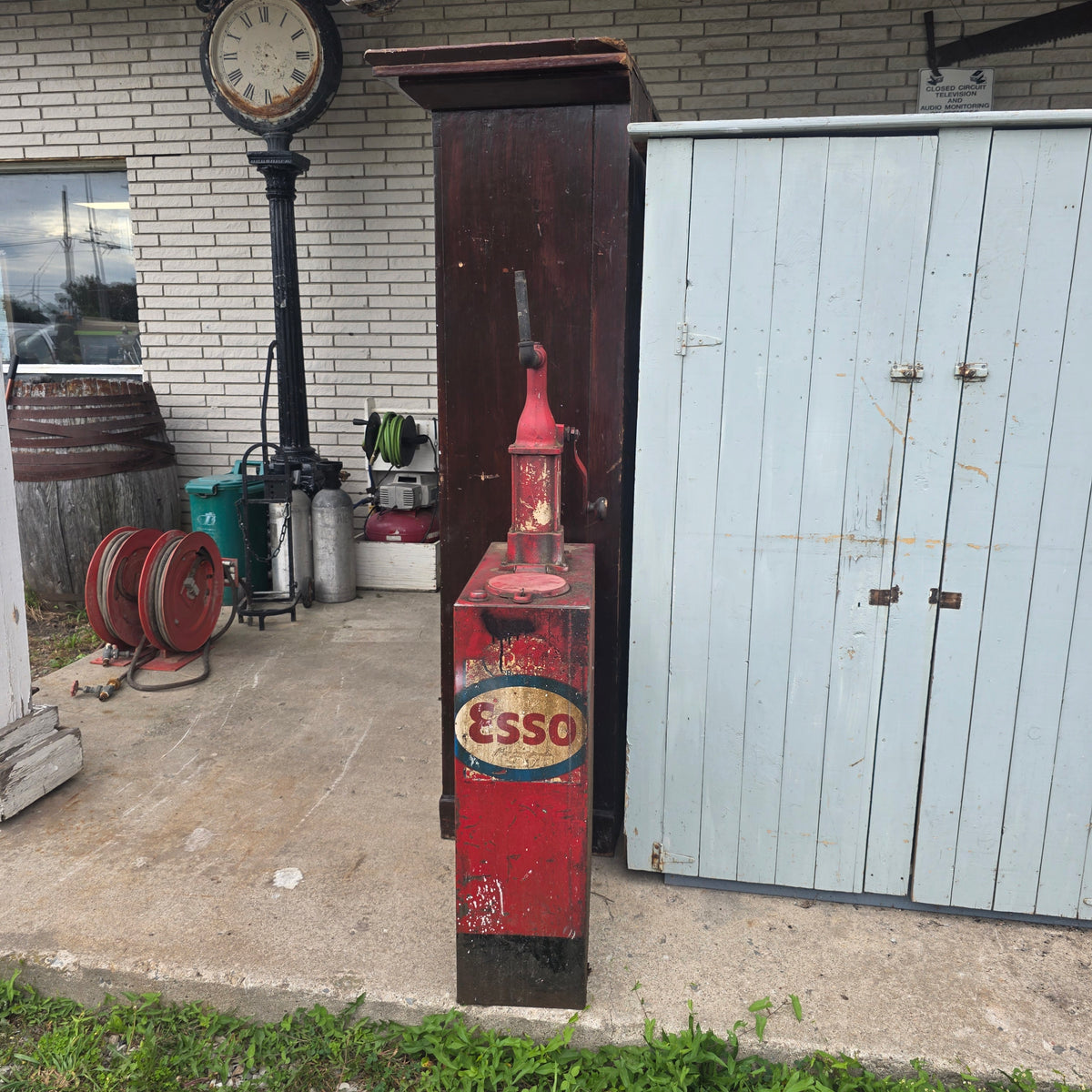 Antique Esso-branded lubester oil tank with Gilbert and Barker brass identification tag
