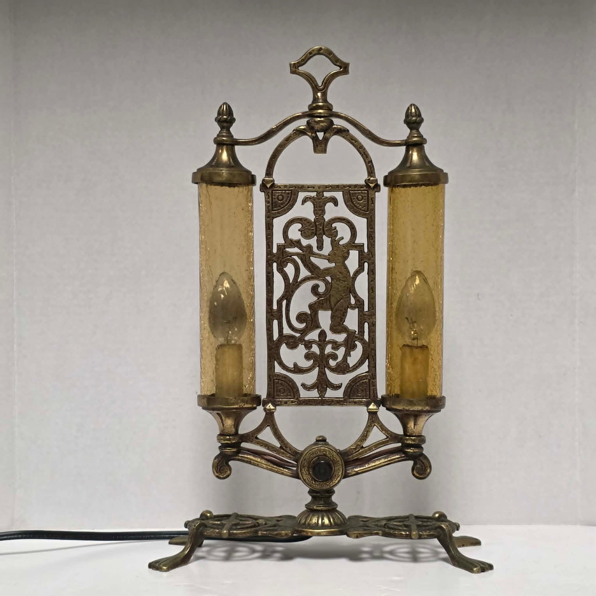 Exceptional Art Deco Mutual Sunset bronze lamp with Pan figure, original patina, and amber glass shades.