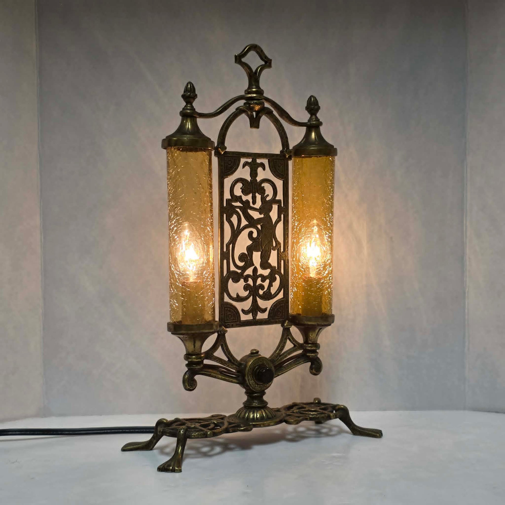 Exceptional Art Deco Mutual Sunset bronze lamp with Pan figure, original patina, and amber glass shades.