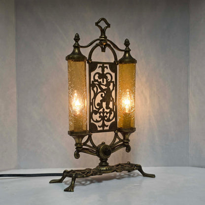 Exceptional Art Deco Mutual Sunset bronze lamp with Pan figure, original patina, and amber glass shades.