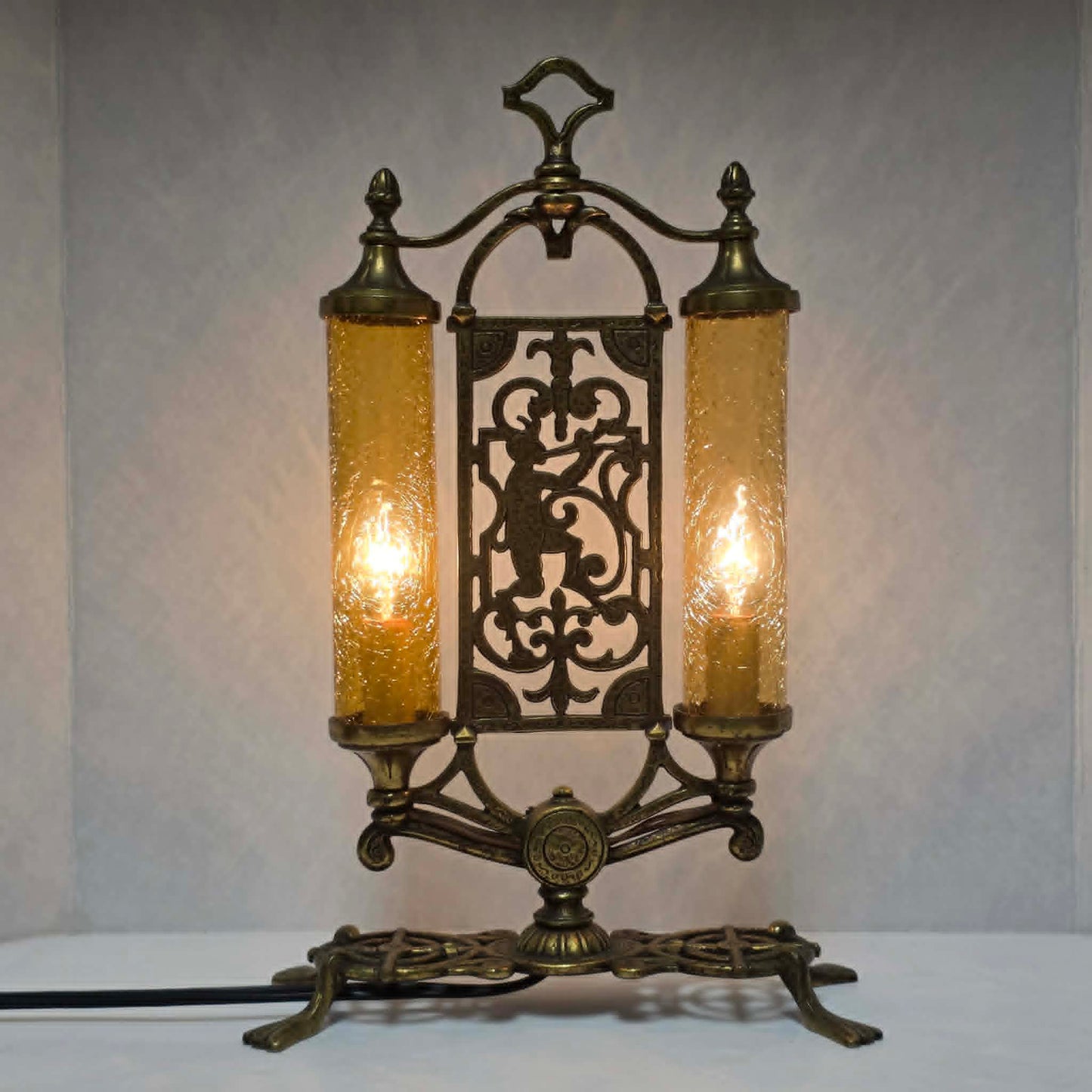 Exceptional Art Deco Mutual Sunset bronze lamp with Pan figure, original patina, and amber glass shades.