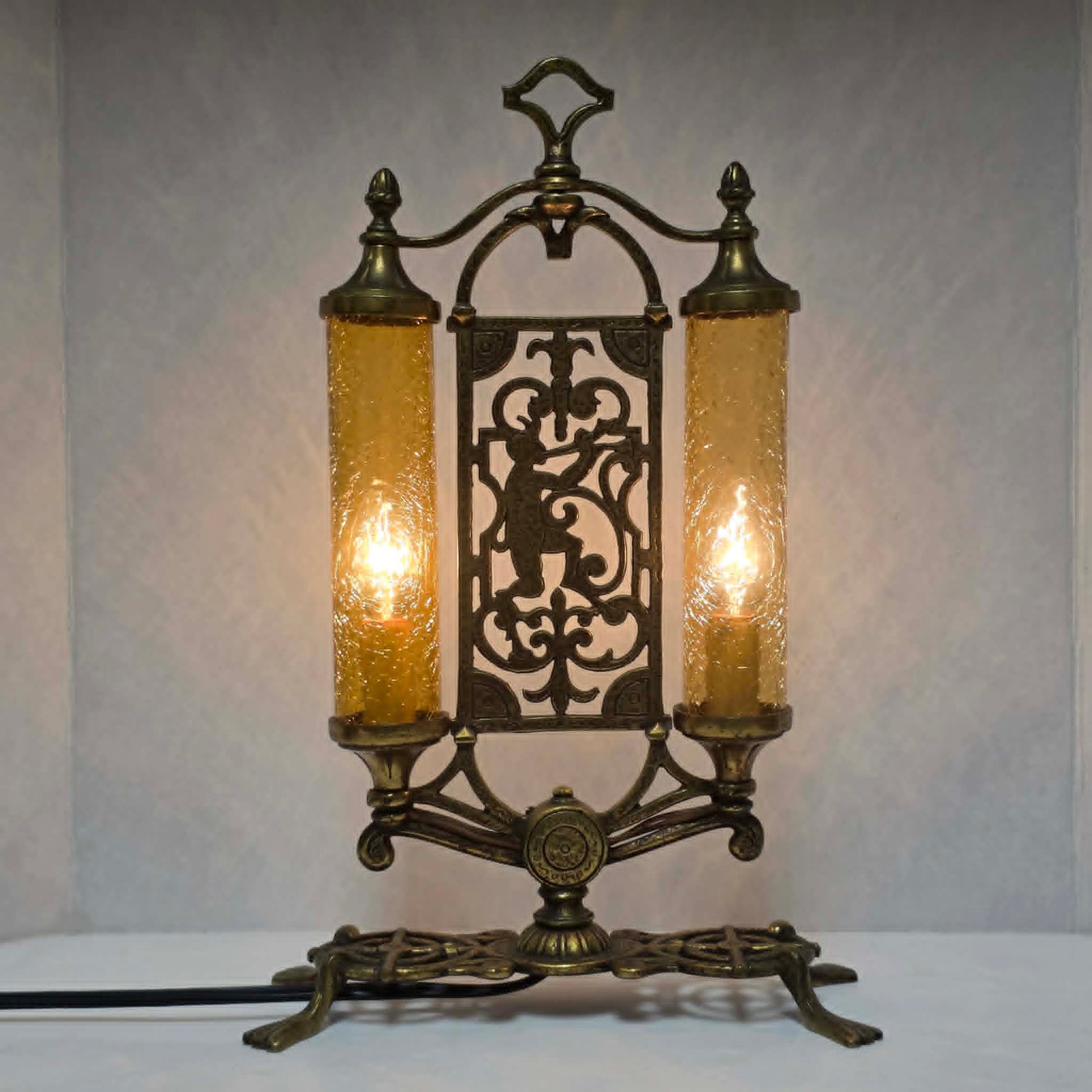 Exceptional Art Deco Mutual Sunset bronze lamp with Pan figure, original patina, and amber glass shades.