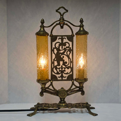 Exceptional Art Deco Mutual Sunset bronze lamp with Pan figure, original patina, and amber glass shades.