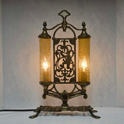 Exceptional Art Deco Mutual Sunset bronze lamp with Pan figure, original patina, and amber glass shades.