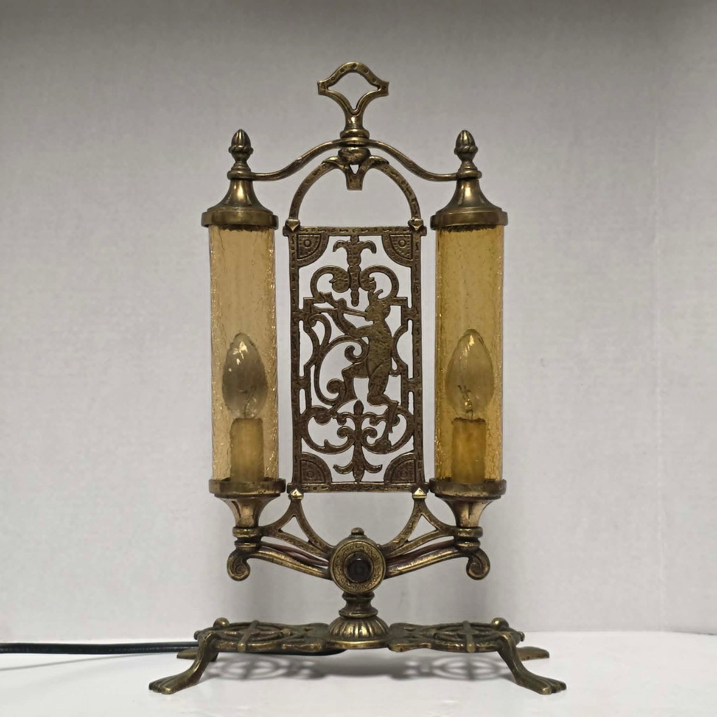 Exceptional Art Deco Mutual Sunset bronze lamp with Pan figure, original patina, and amber glass shades.