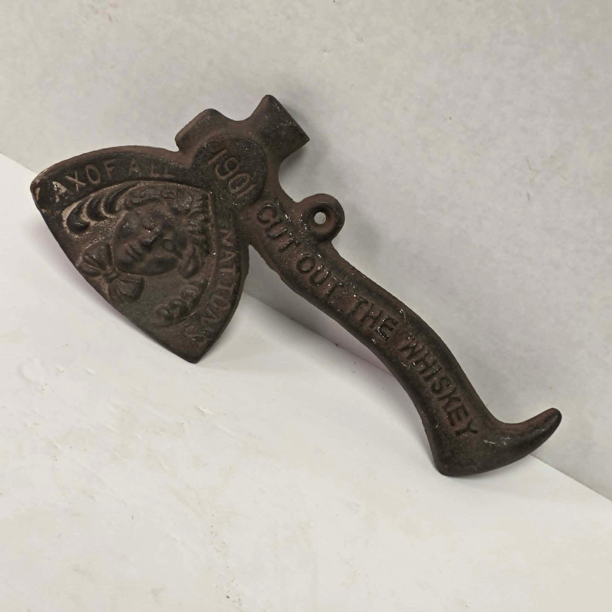 Early 1900s cast iron Carrie Nation temperance advertising axe with detailed relief portrait and slogan.