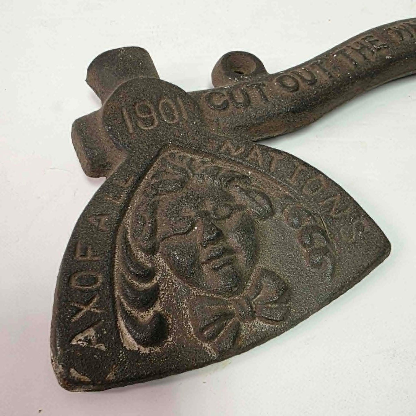 Early 1900s cast iron Carrie Nation temperance advertising axe with detailed relief portrait and slogan.