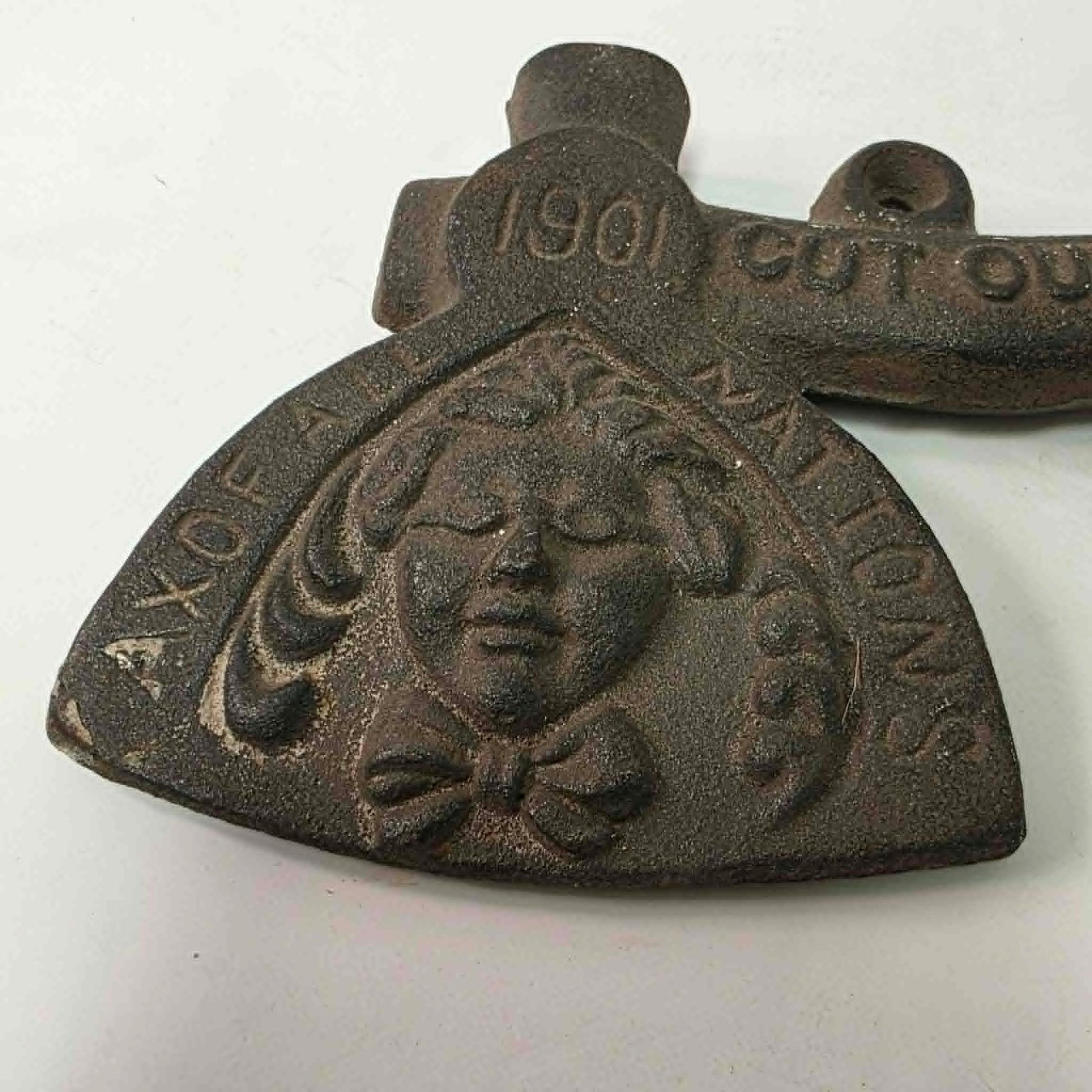 Early 1900s cast iron Carrie Nation temperance advertising axe with detailed relief portrait and slogan.
