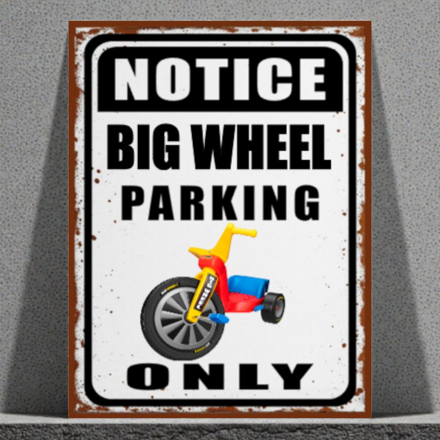 Metal sign with a tricycle graphic and text 'Notice Big Wheel Parking Only' on a gray background