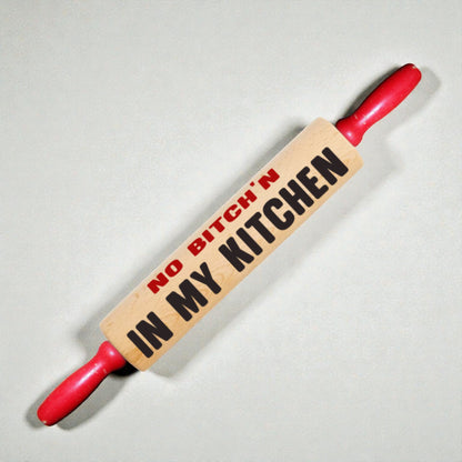 Rolling pin with 'No Bitch'n in My Kitchen' text on a light background