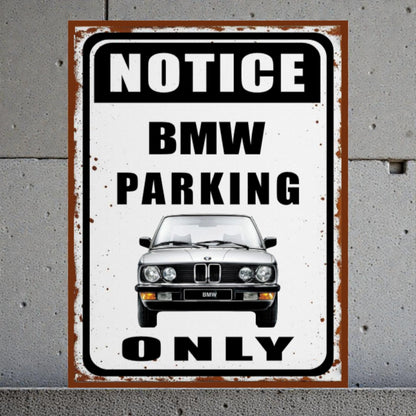 Vintage-style sign with BMW logo on a gray concrete wall