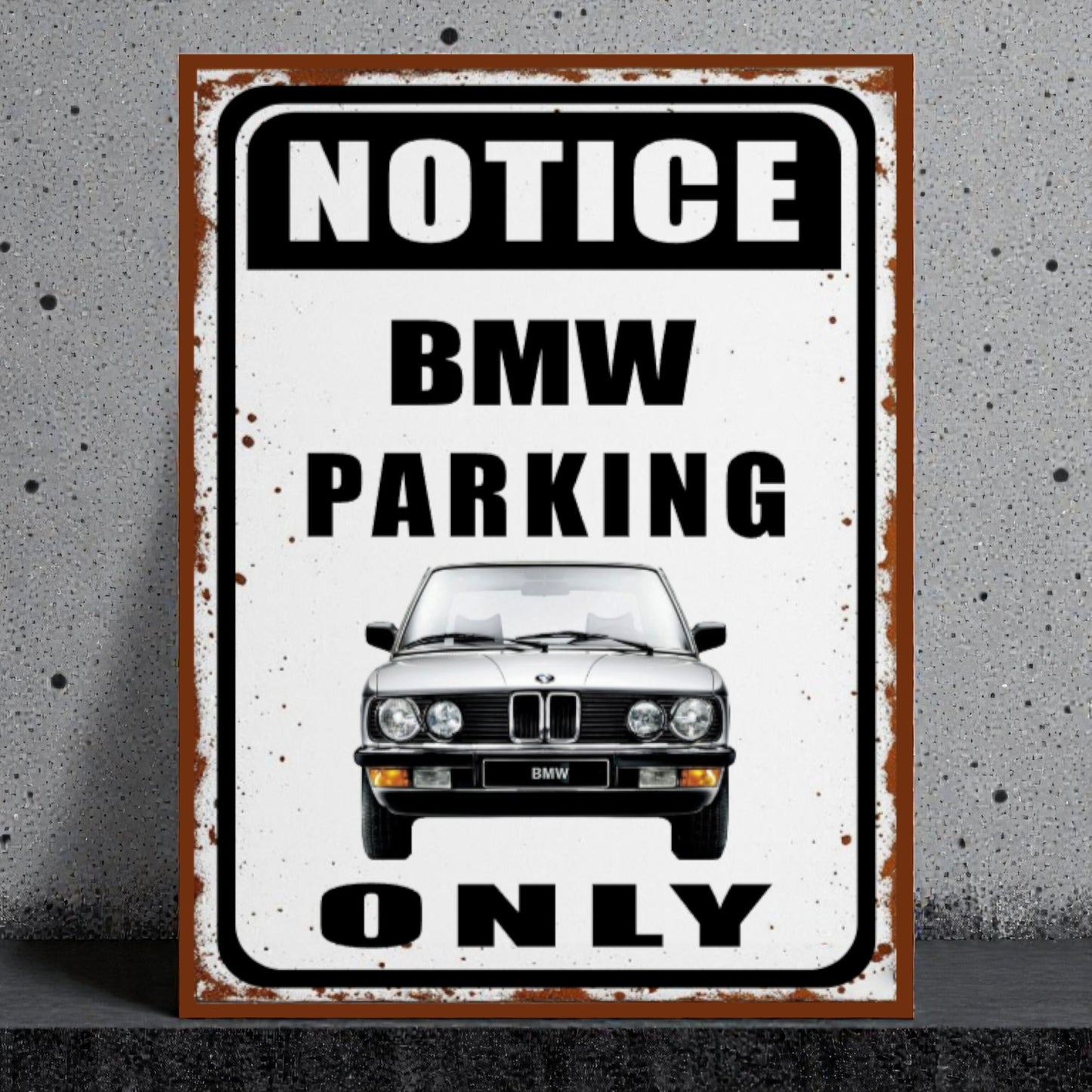 Vintage-style metal sign with BMW car illustration and 'Notice BMW Parking Only' text on a textured wall background.