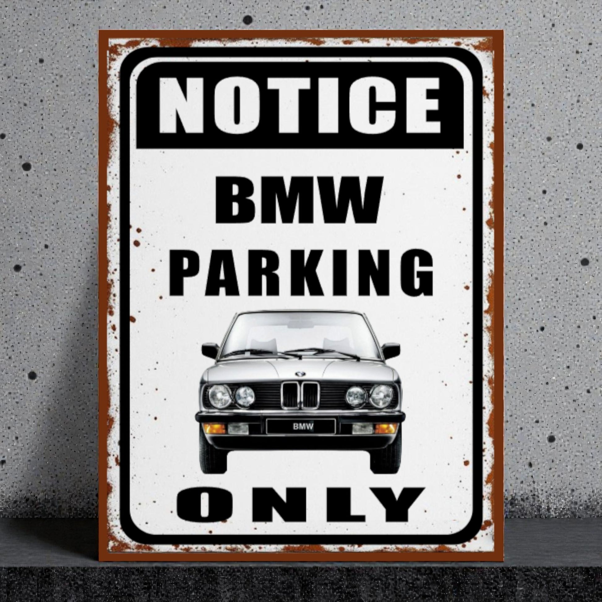Vintage-style metal sign with BMW car illustration and 'Notice BMW Parking Only' text on a textured wall background.