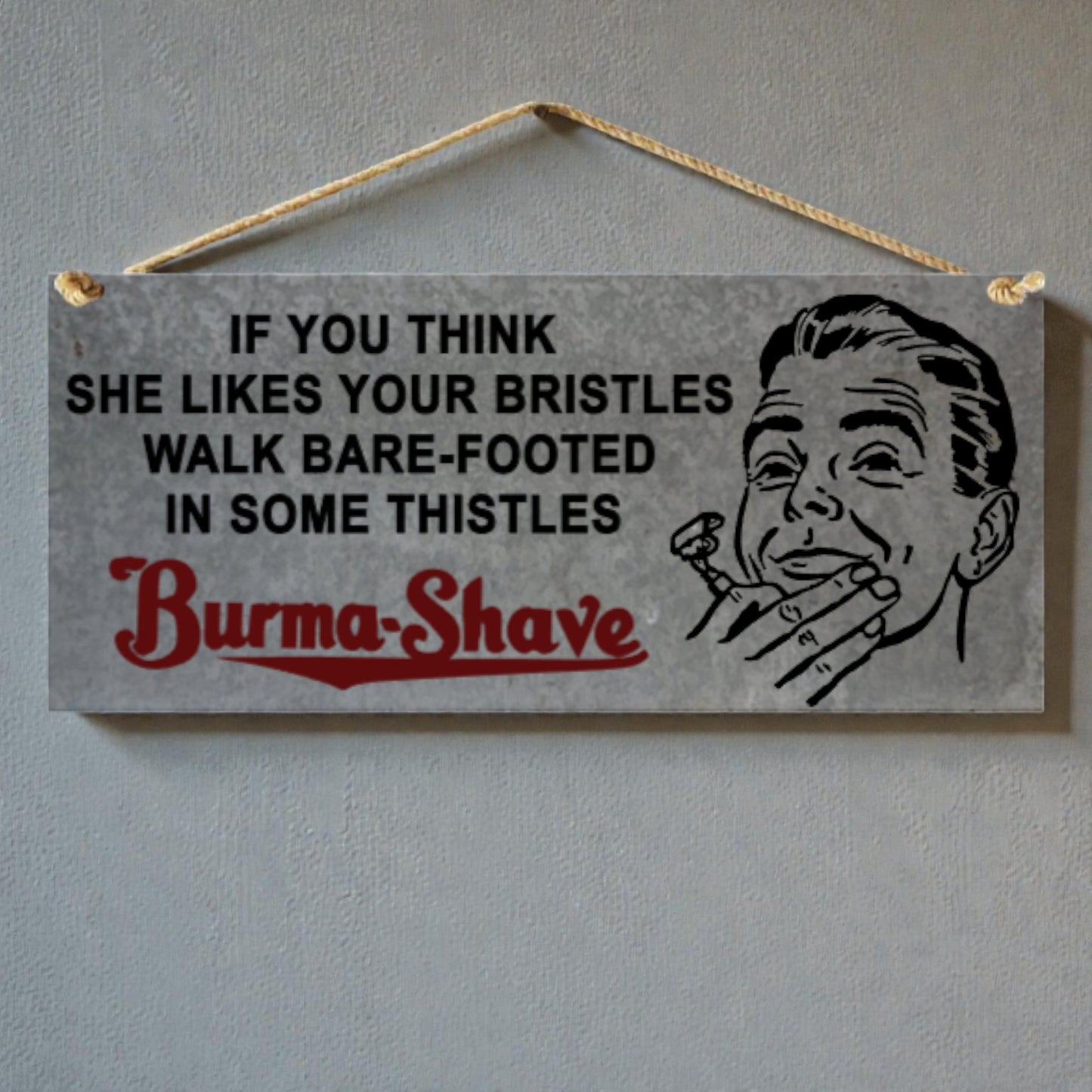 Vintage-style sign with humorous text and illustration of a man with a razor, hanging on a wall.