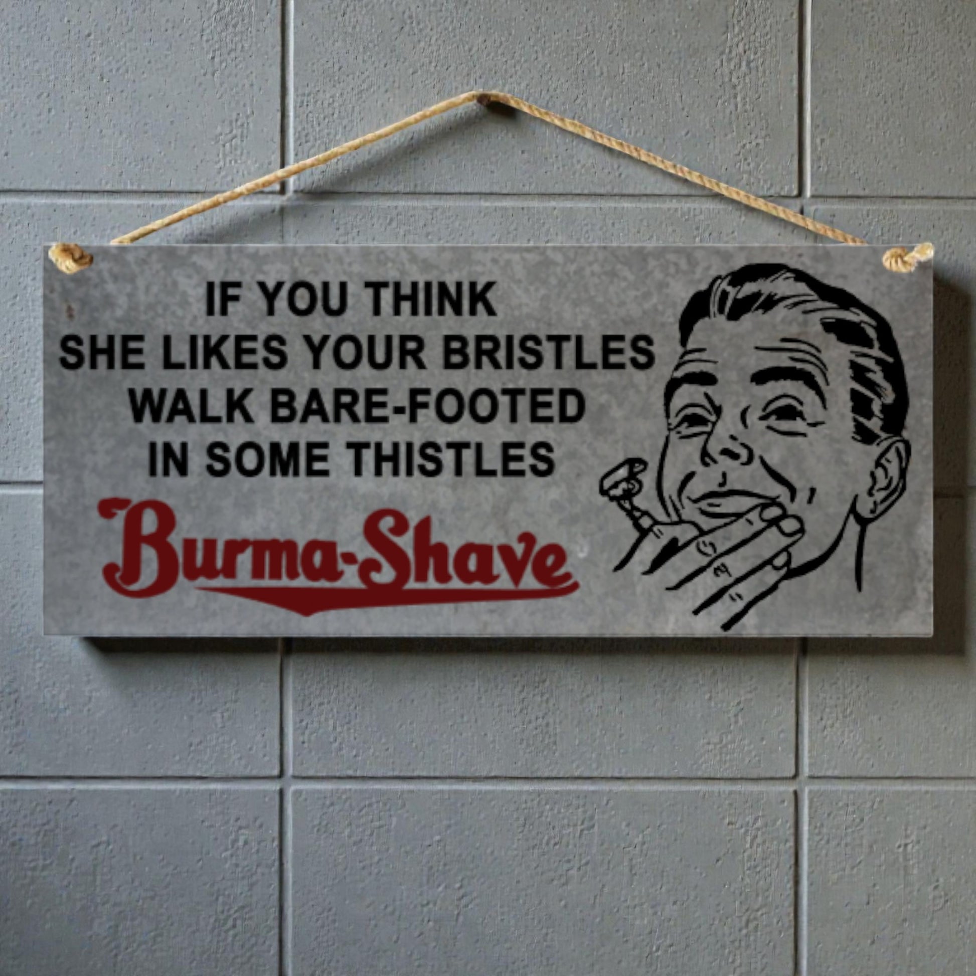 Vintage-style sign with text and illustration of a man with a razor, hanging on a tiled wall.