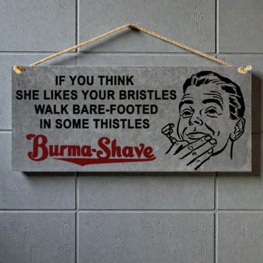 Vintage-style sign with text and illustration of a man with a razor, hanging on a tiled wall.