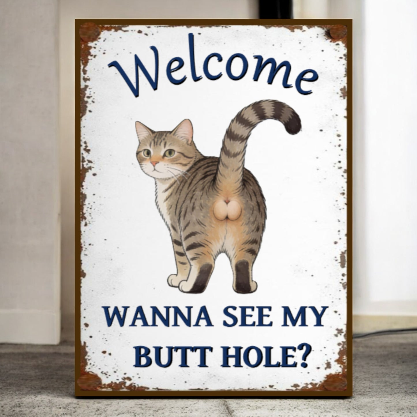 Sign with a cat illustration and humorous text on a white background