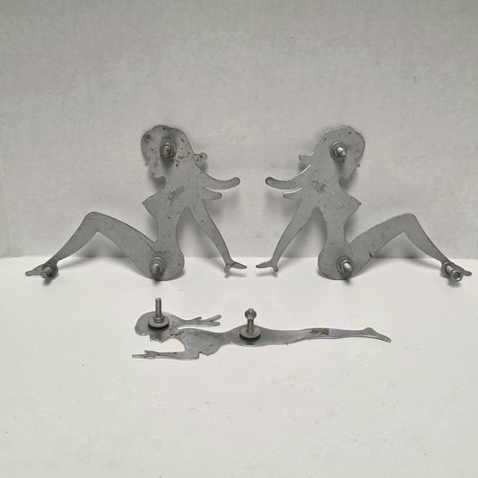 Set of three stainless steel vintage trucker mud flap girl decorations.
