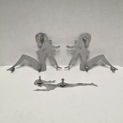 Set of three stainless steel vintage trucker mud flap girl decorations.
