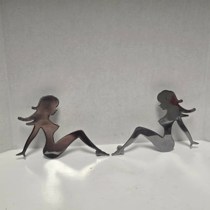 Set of three stainless steel vintage trucker mud flap girl decorations.
