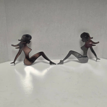 Set of three stainless steel vintage trucker mud flap girl decorations.
