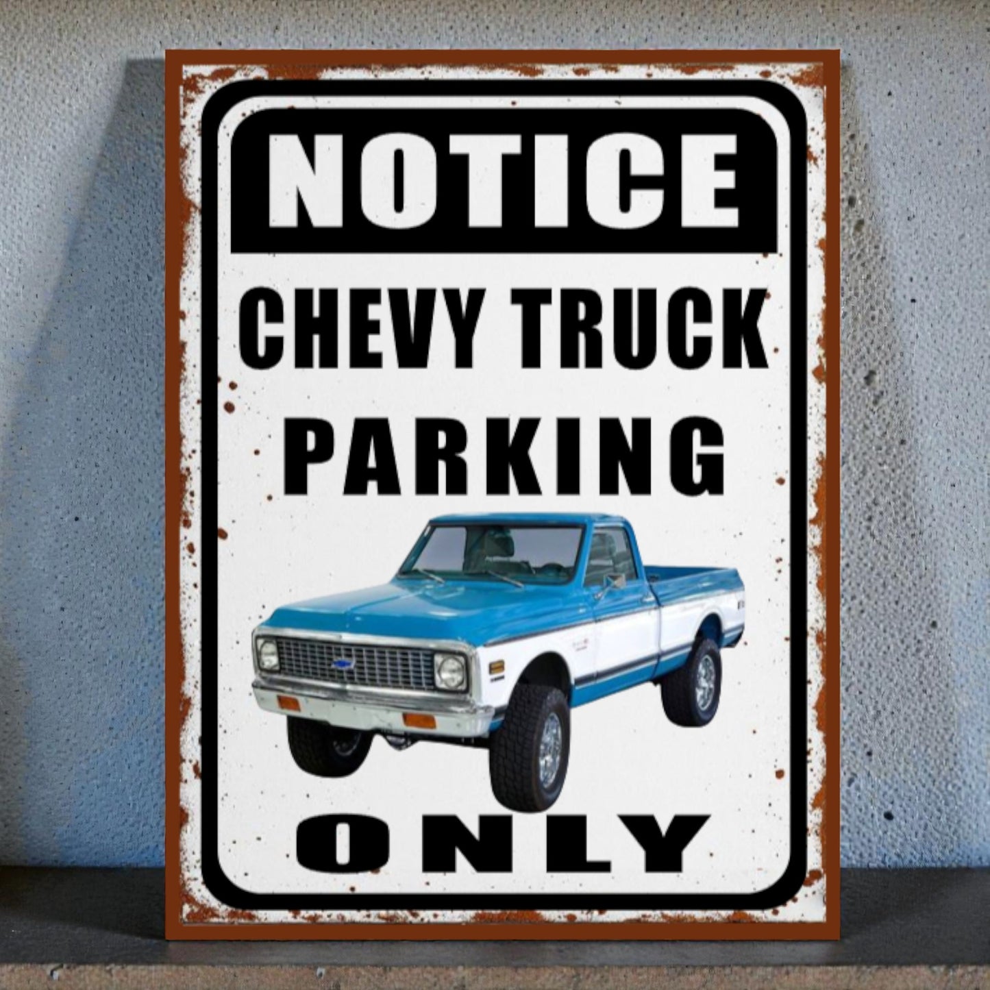 Vintage-style sign with a blue and white Chevy truck and text 'Notice Chevy Truck Parking Only' on a gray background.