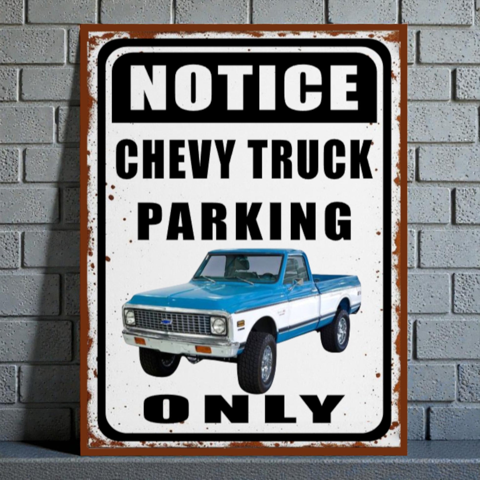 Vintage-style metal sign with a blue and white Chevy truck and text 'Notice Chevy Truck Parking Only' on a brick wall background.