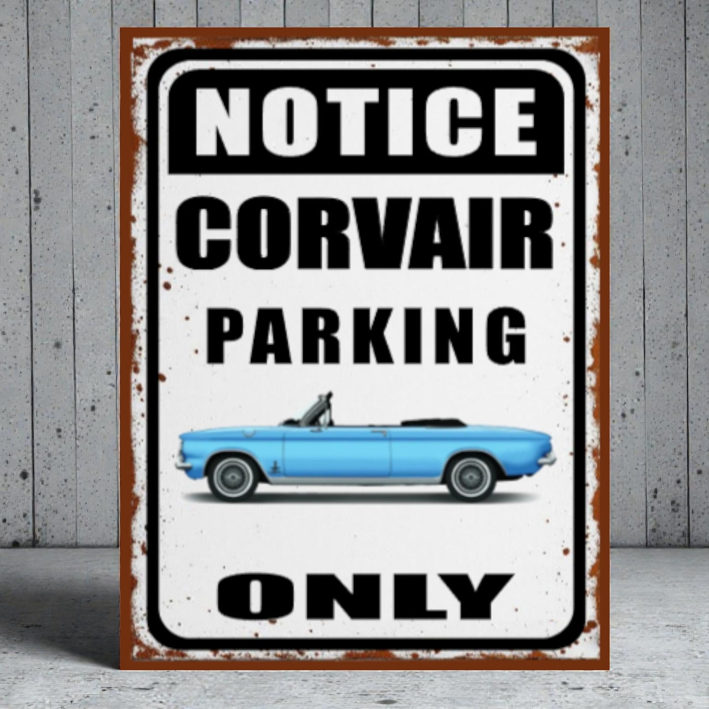 Vintage-style metal sign with a blue Corvair car and 'Notice Corvair Parking Only' text on a wooden background.