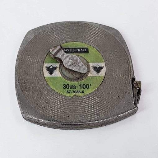 Vintage Mastercraft tape measure on a white background