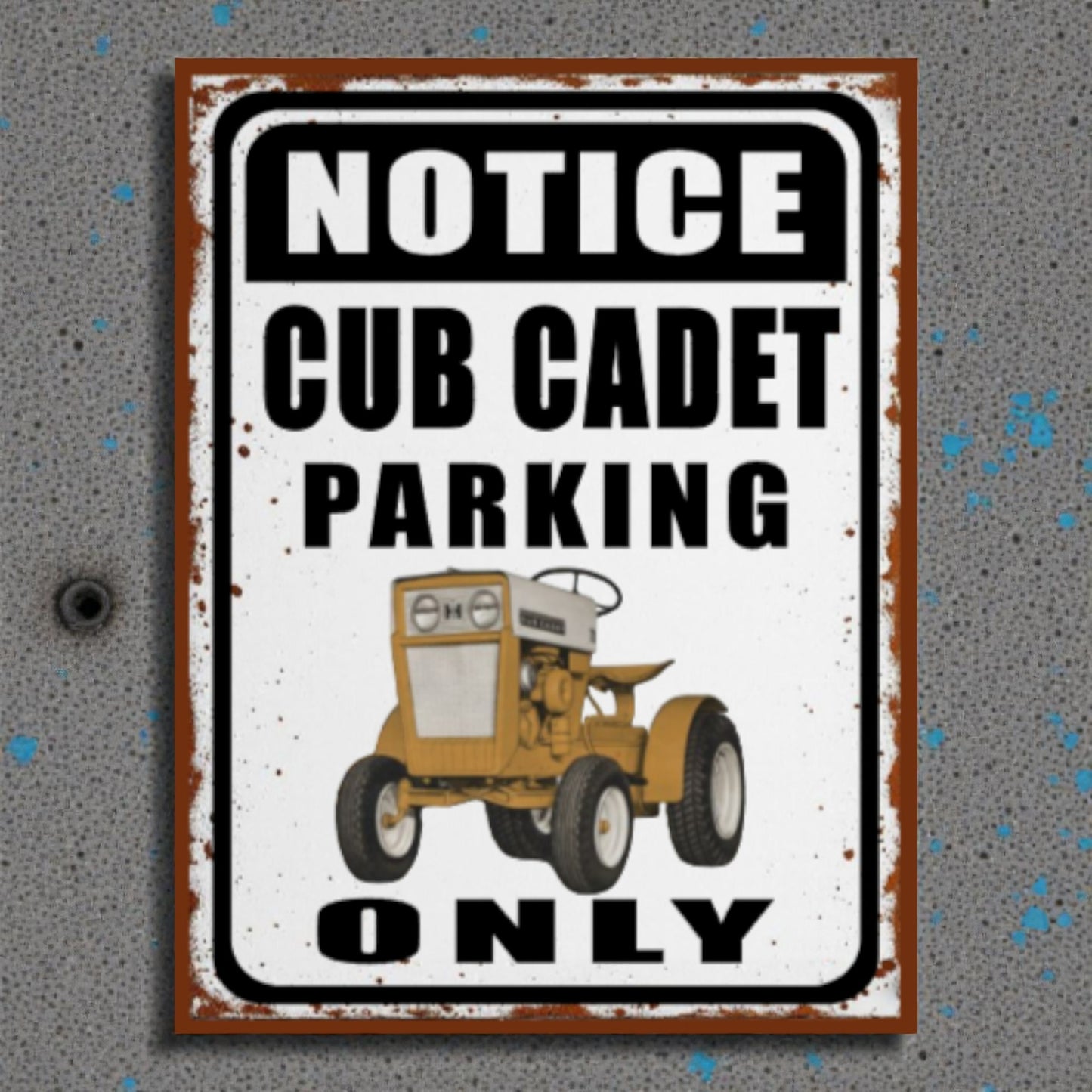 Metal sign with a vintage tractor illustration and text 'Notice Cub Cadet Parking Only' on a textured gray background.