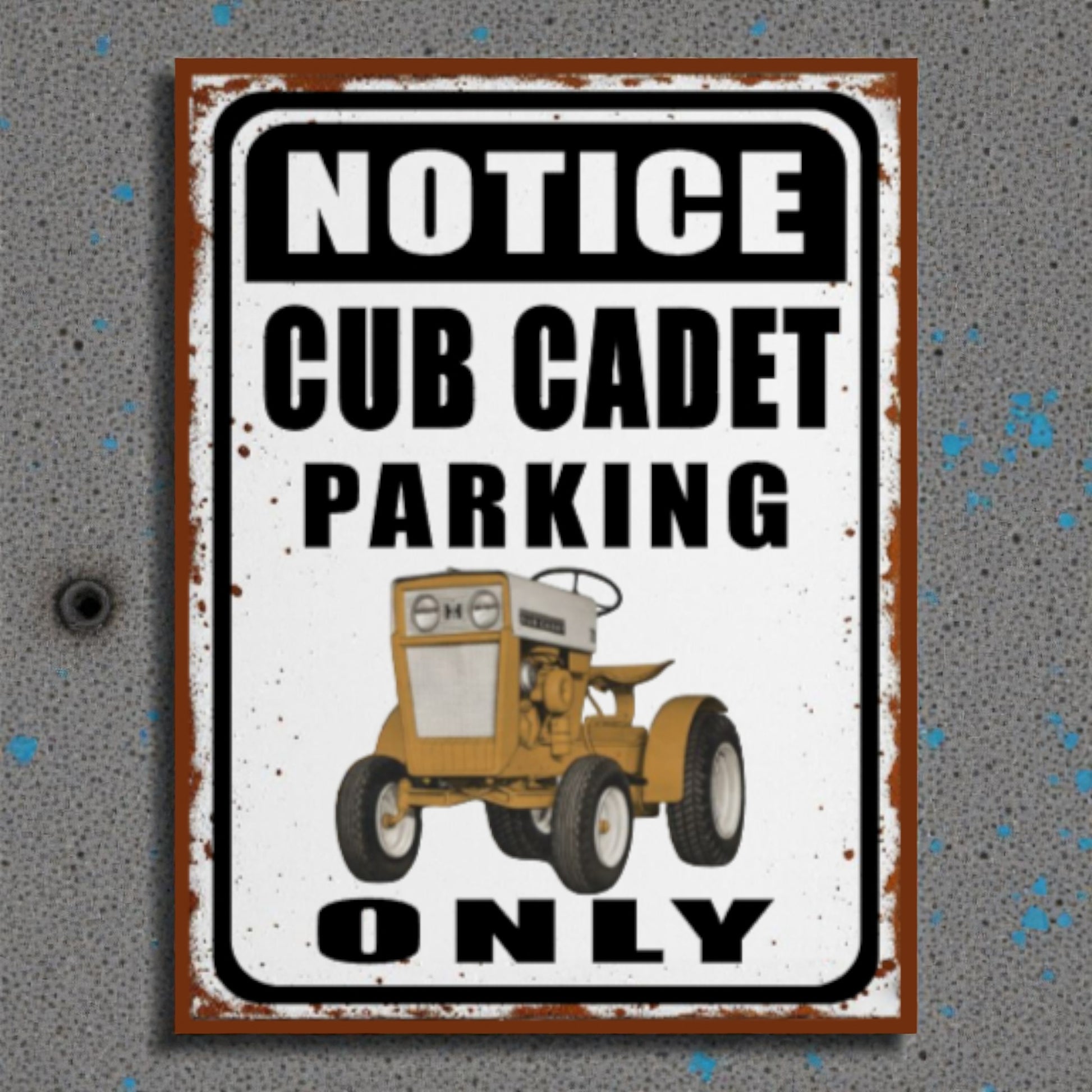 Metal sign with a vintage tractor illustration and text 'Notice Cub Cadet Parking Only' on a textured gray background.