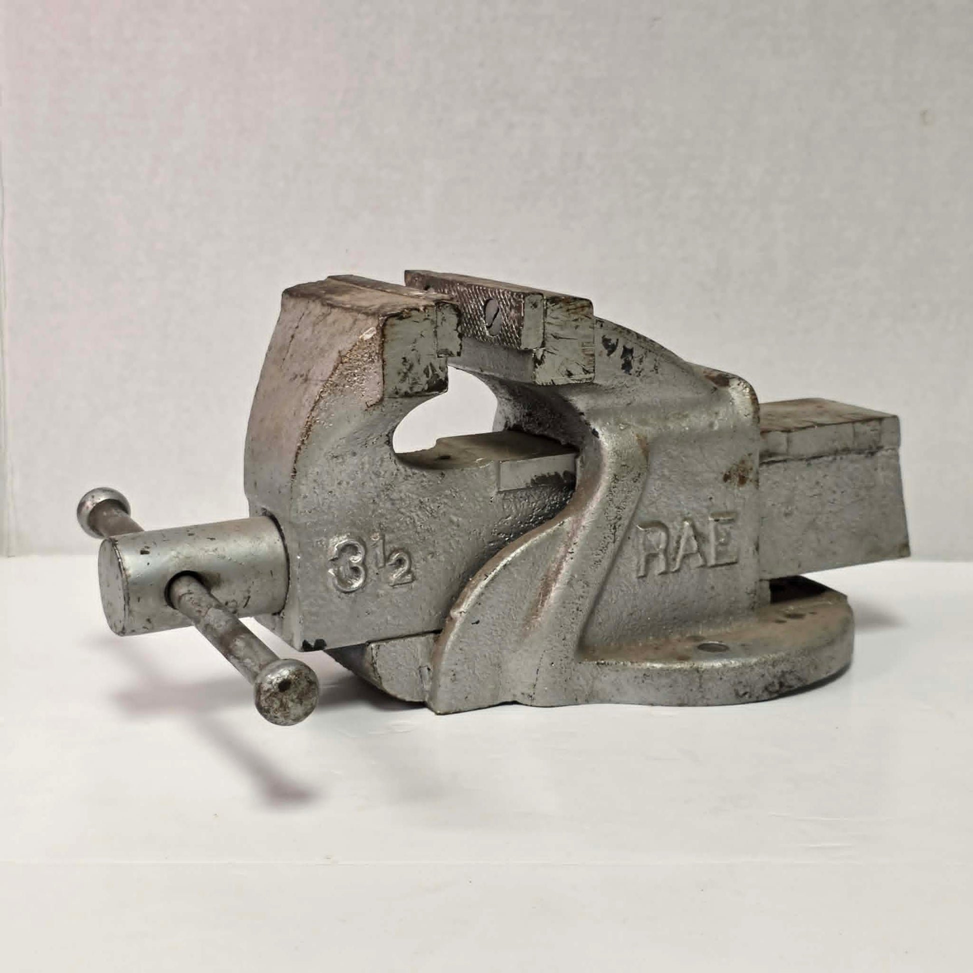 Heavy-duty antique RAE bench vise from Hamilton, Canada with 3.5-inch jaws and industrial steel construction.