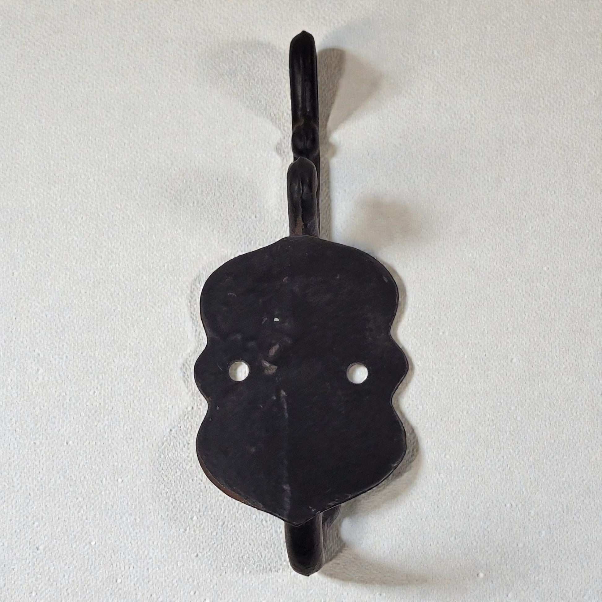 Black metal hook on a white background