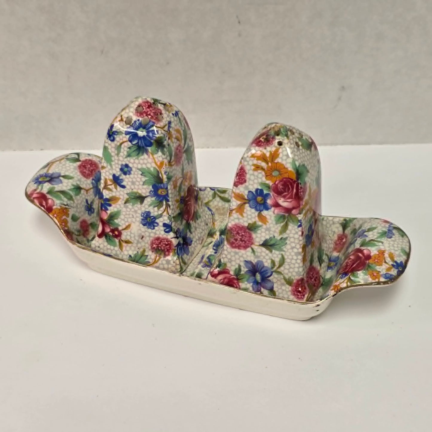 Antique Royal Grimwades Old Cottage Chintz salt and pepper shakers with matching tray.
