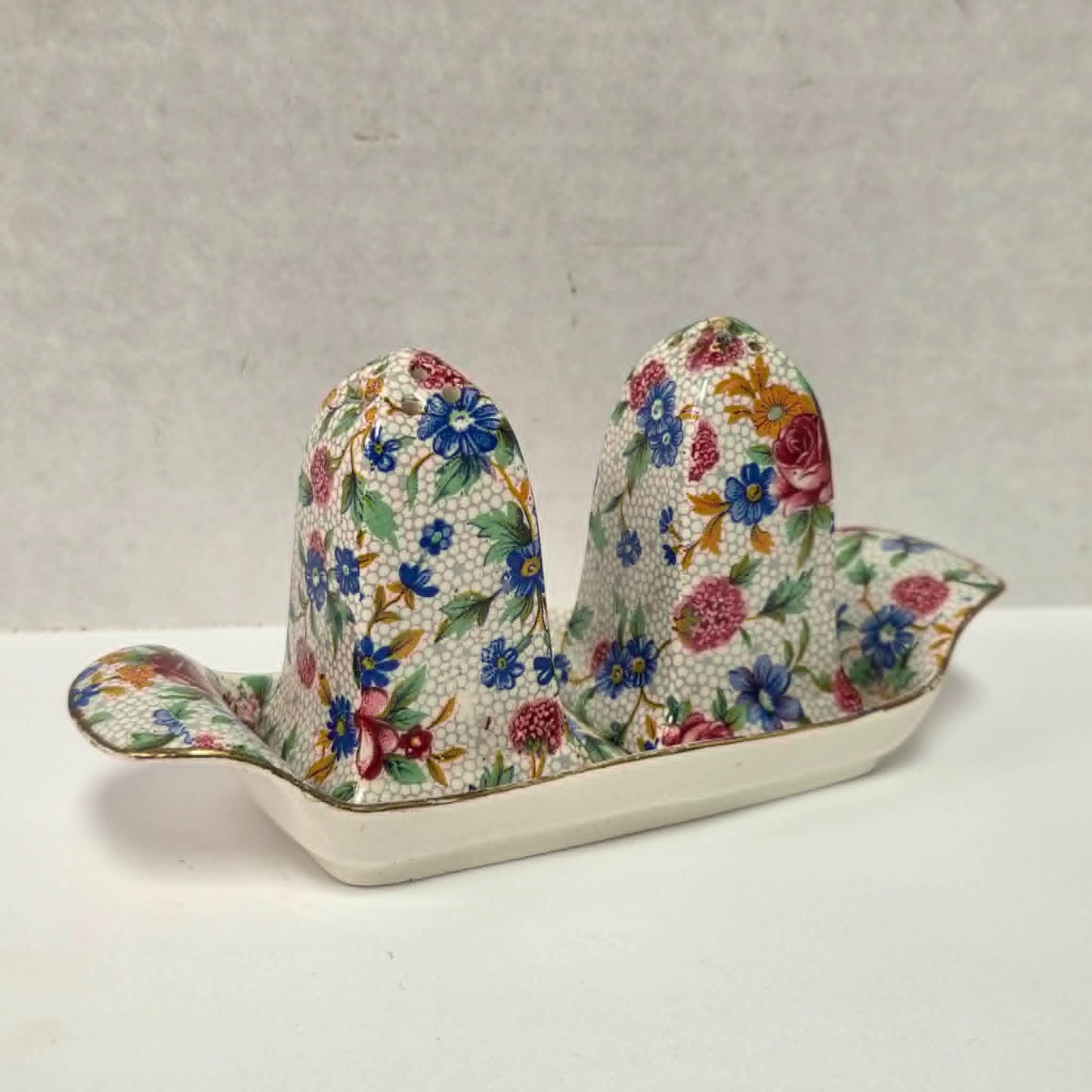Antique Royal Grimwades Old Cottage Chintz salt and pepper shakers with matching tray.

